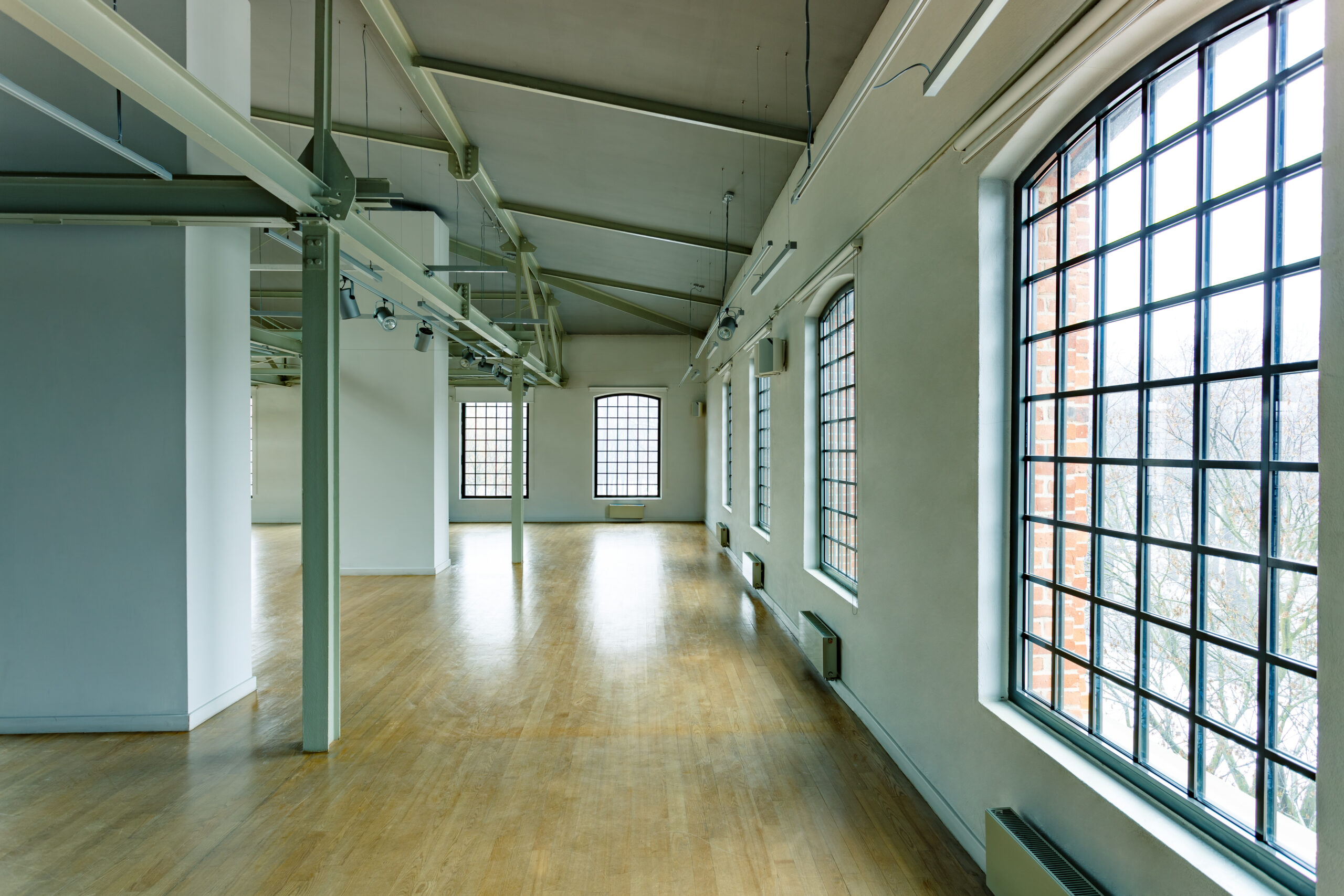 Empty commercial loft interior with large industrial windows
