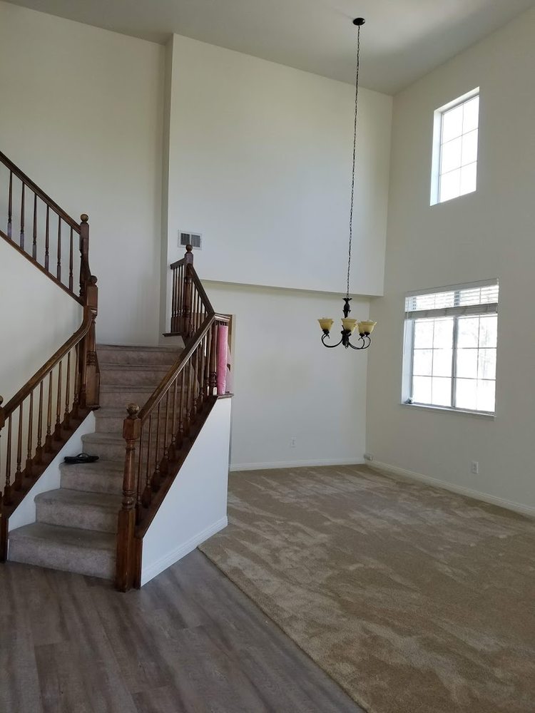 A freshly painted living area with a staircase by interior painting services in Riverside, CA.