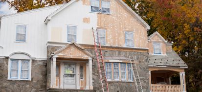 A Riverside home mid-renovation by Victory Paints & Services Inc. with scaffolding in place.