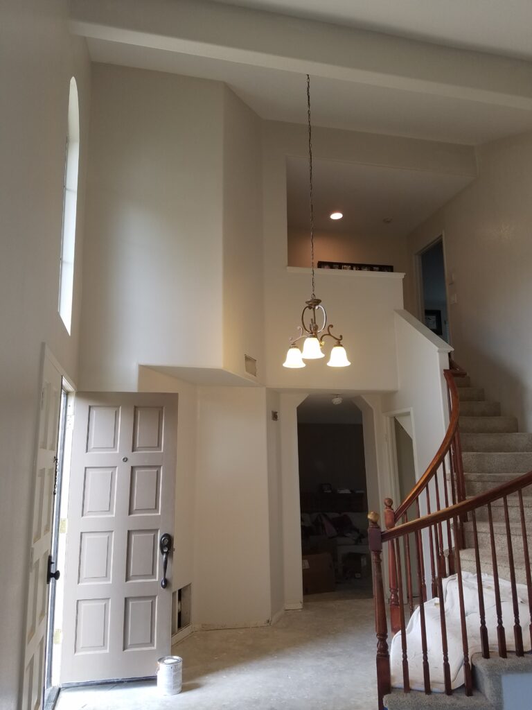 A freshly painted entryway and staircase area with neutral tones, completed by a painting company in Murrieta, CA.