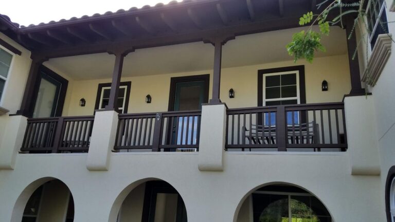 Exterior of a two-story residential building with freshly painted walls and trim by professional painters in Riverside