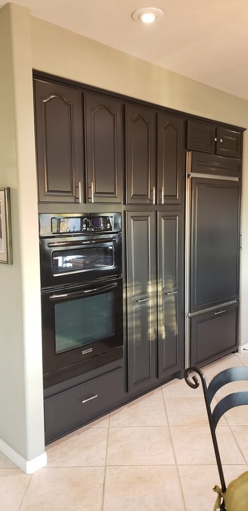 Kitchen cabinets after being painted dark by interior painting services in Riverside, CA.