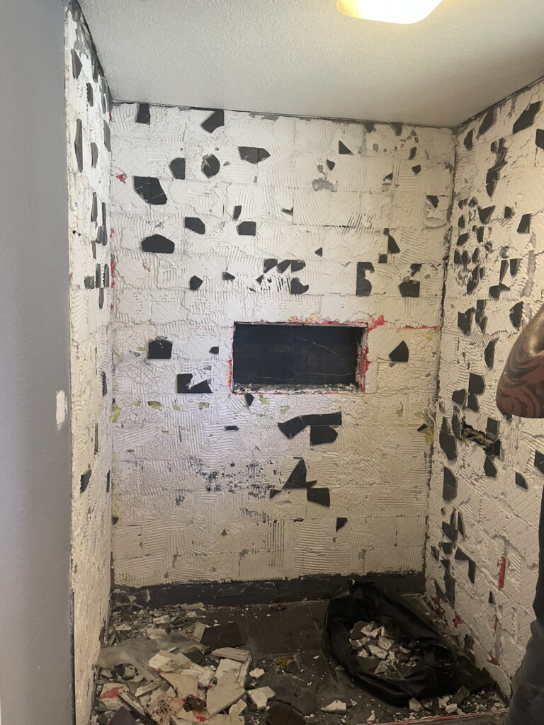 A bathroom stripped down to the walls, awaiting interior painting services in Riverside, CA.