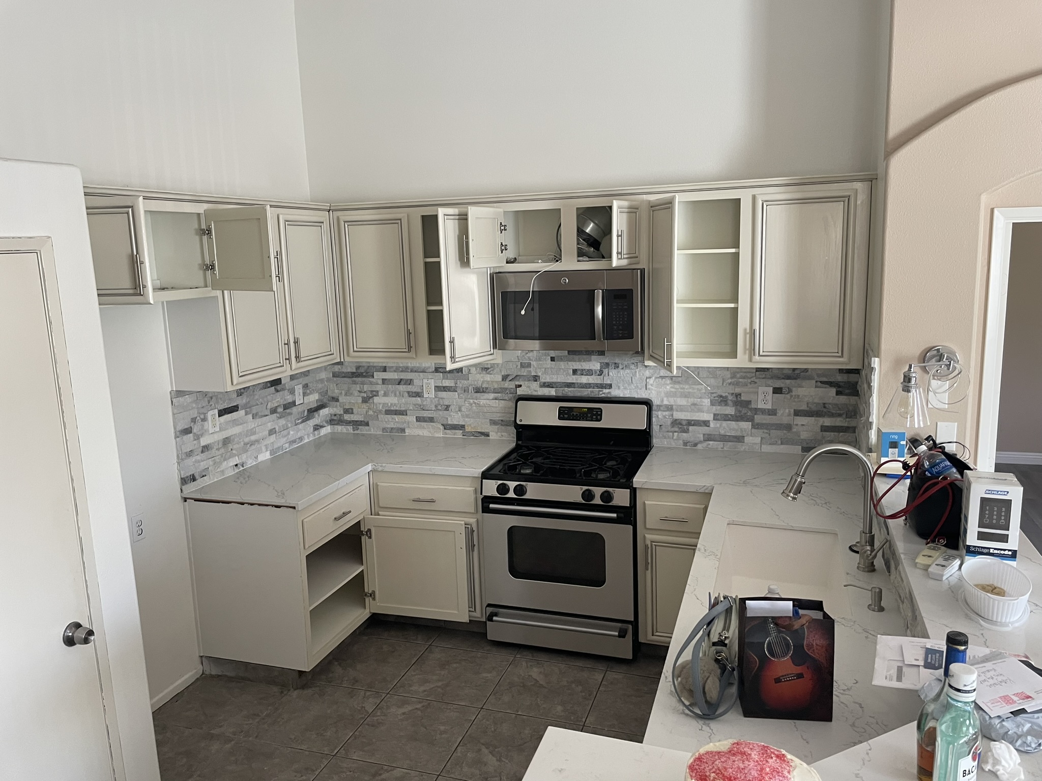 Kitchen with refinished white cabinets and dark appliances