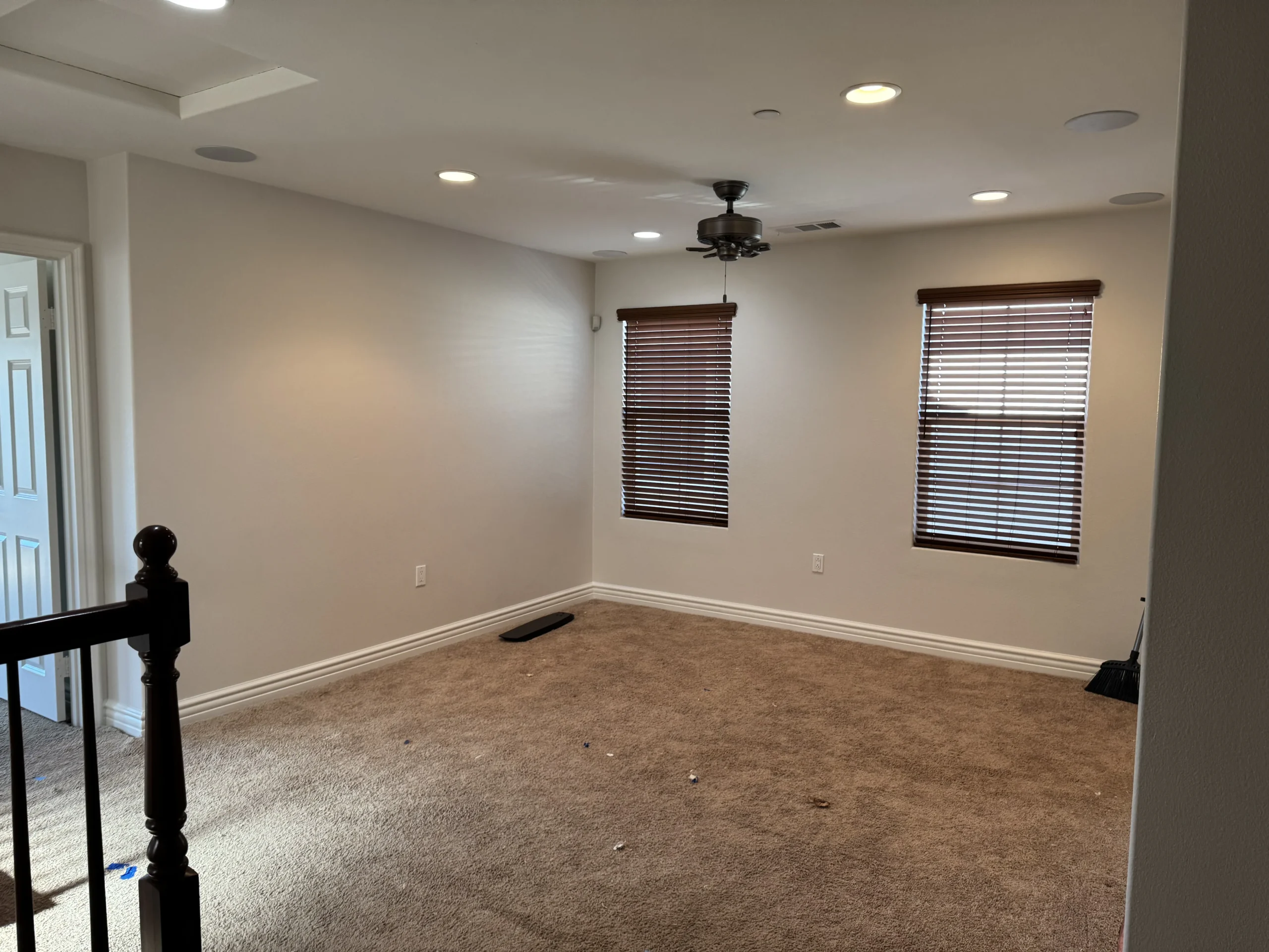 Freshly painted empty room with neutral walls and recessed lighting