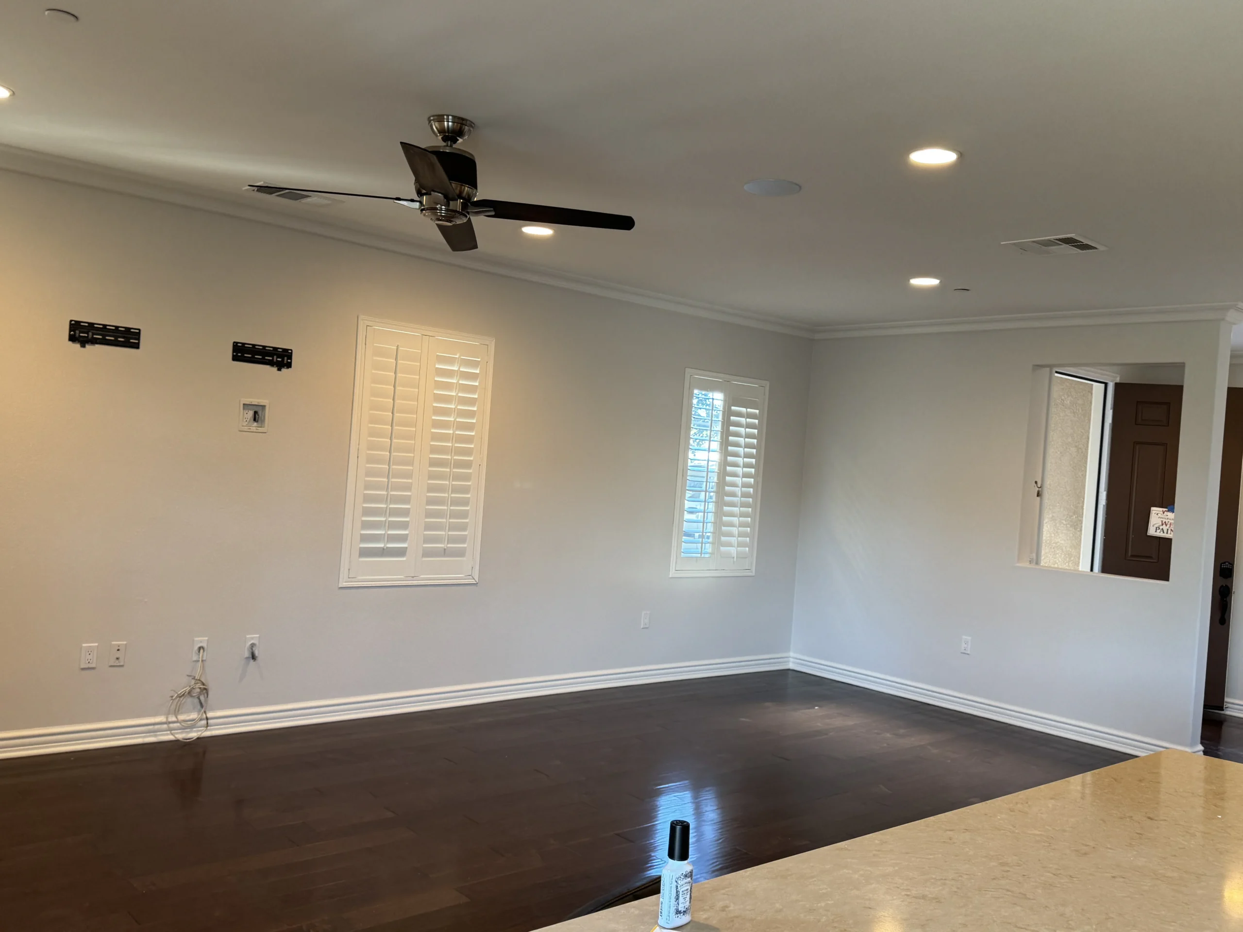 Finished living room with neutral walls and dark hardwood flooring