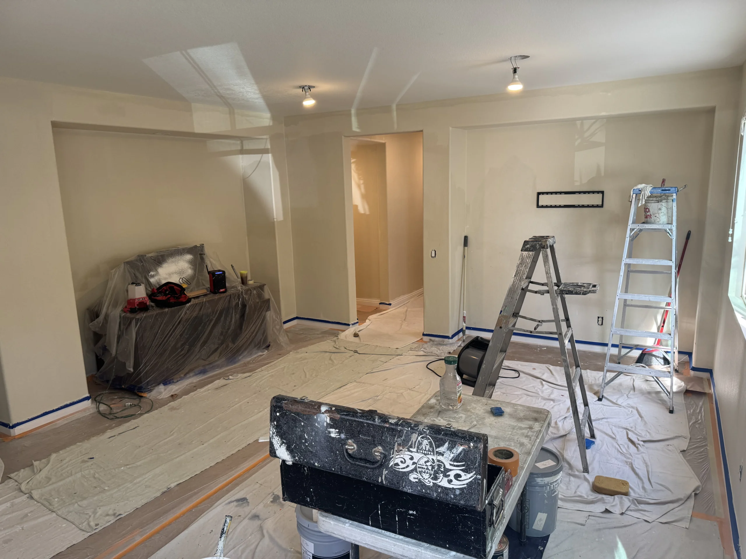 Living room protected with floor coverings for interior painting
