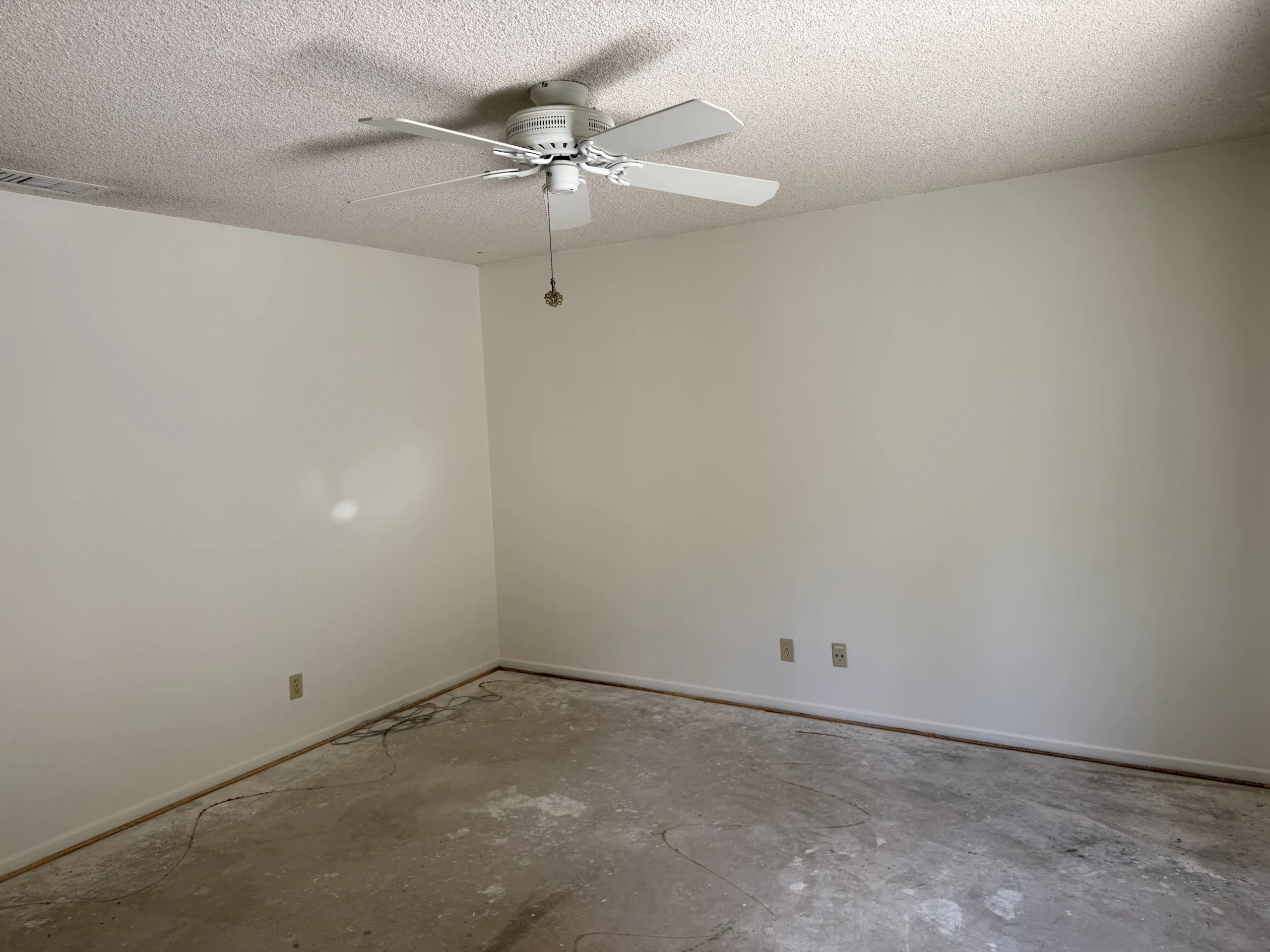 Freshly painted empty bedroom with neutral walls and ceiling fan