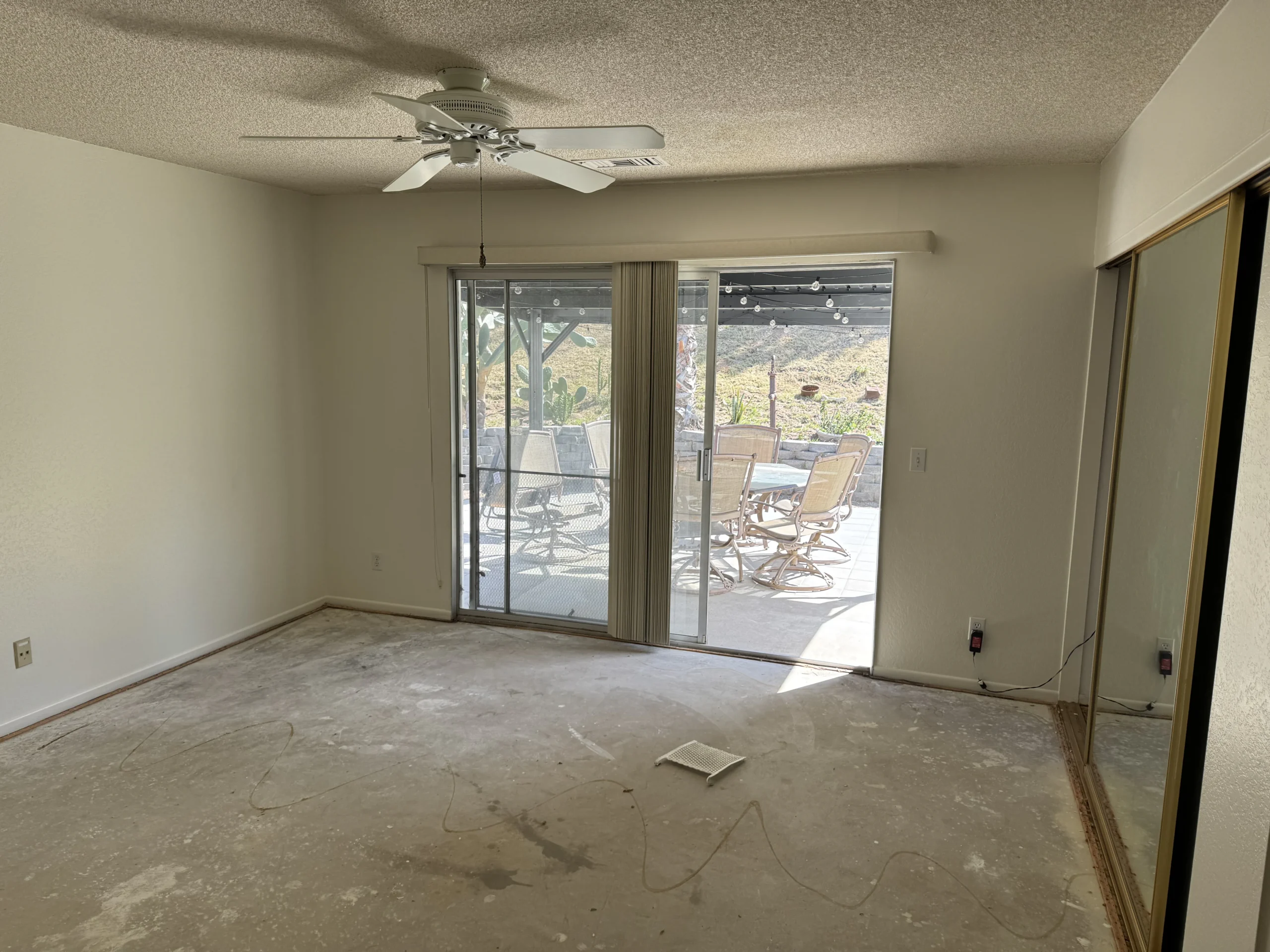 Empty living room with neutral walls and a sliding glass door