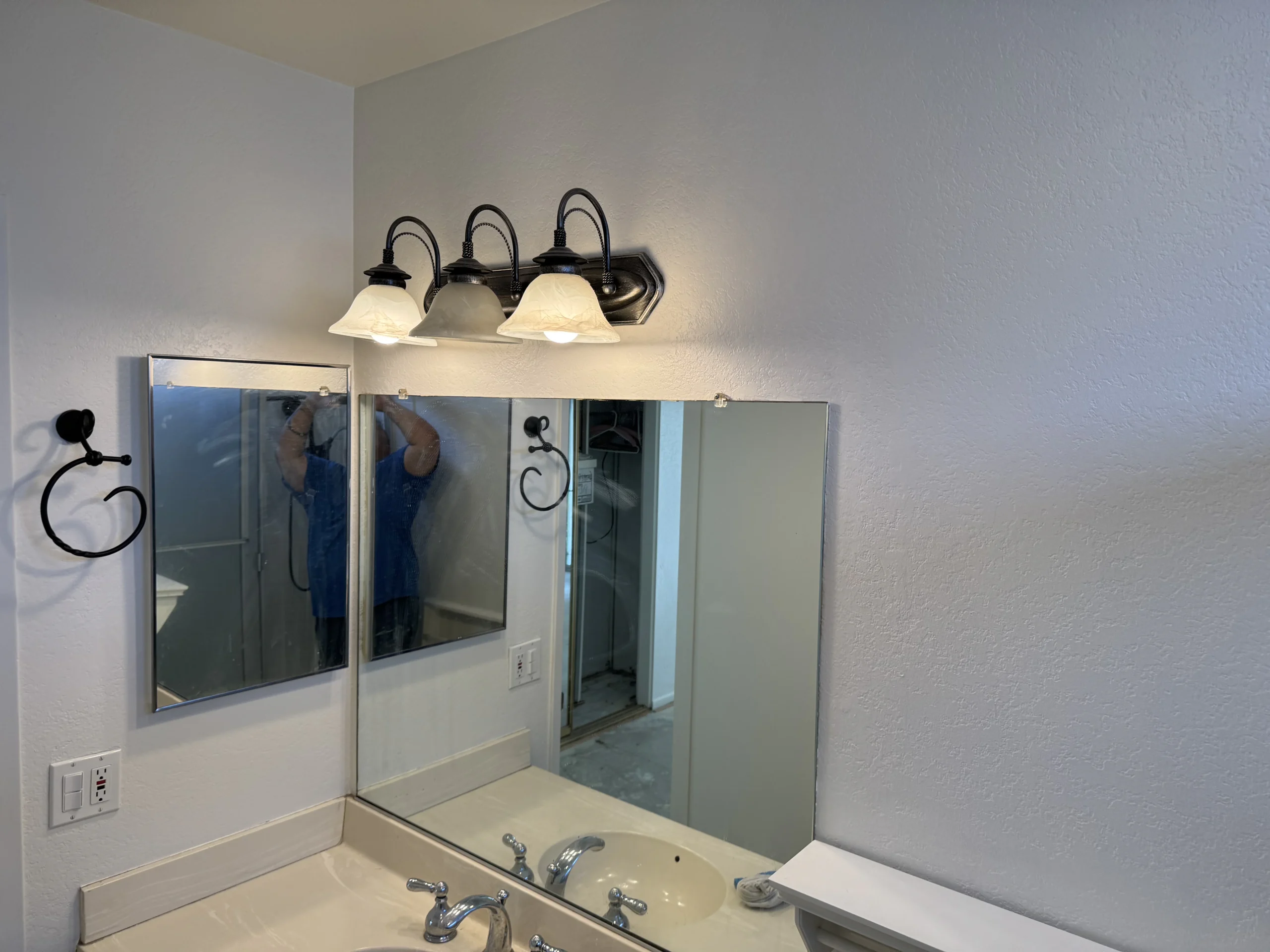 Bathroom vanity with mirrored medicine cabinets and modern lighting